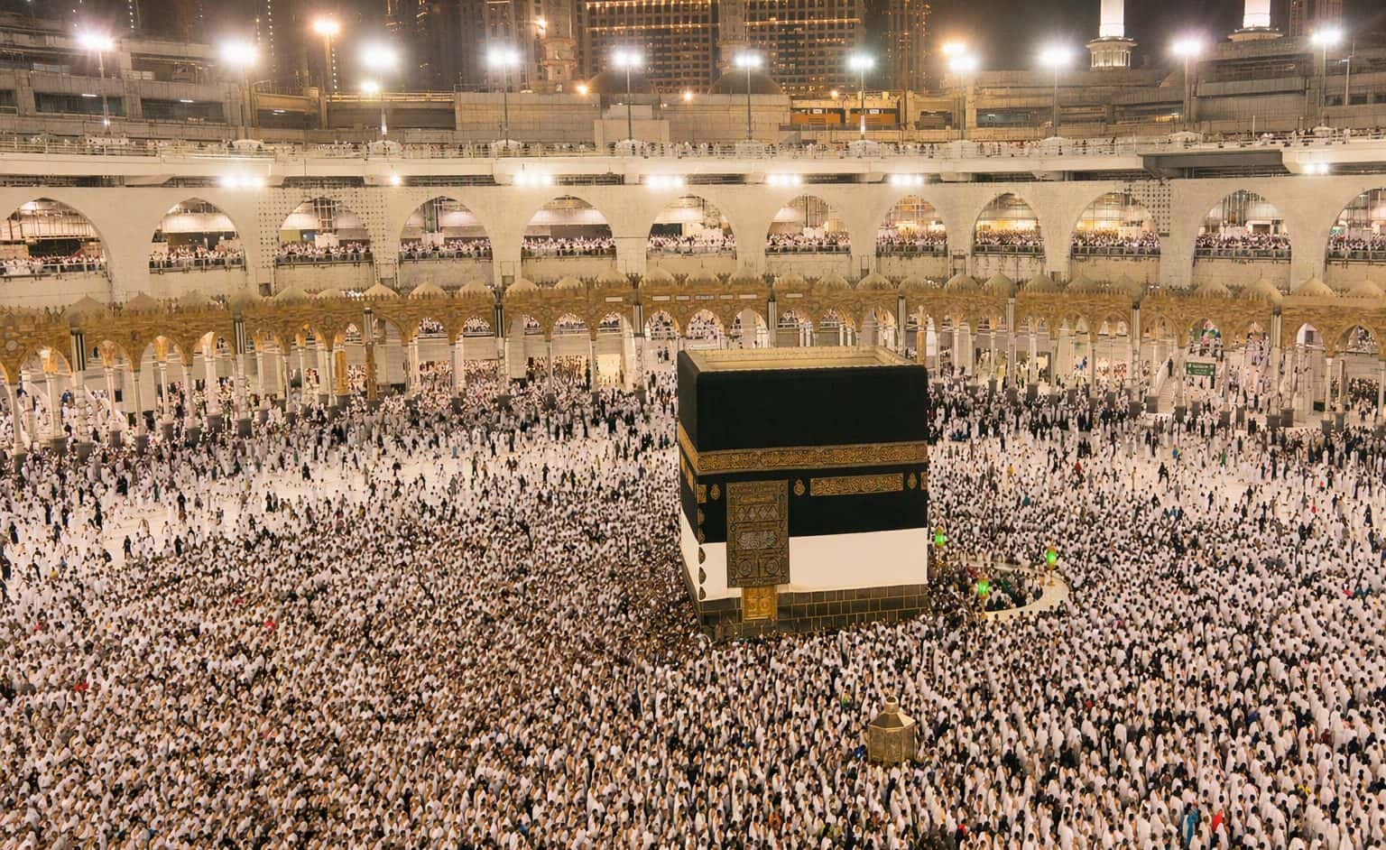 Pilgrims performing tawaf around the Kaaba at night